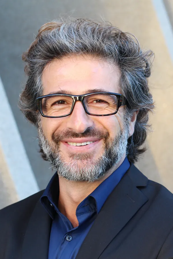 Andropause-and-Low-Testosterone-Treatment A man in Newfoundland with glasses, salt and pepper hair and a beard smiling because he received treatment for andropause and low testosterone.