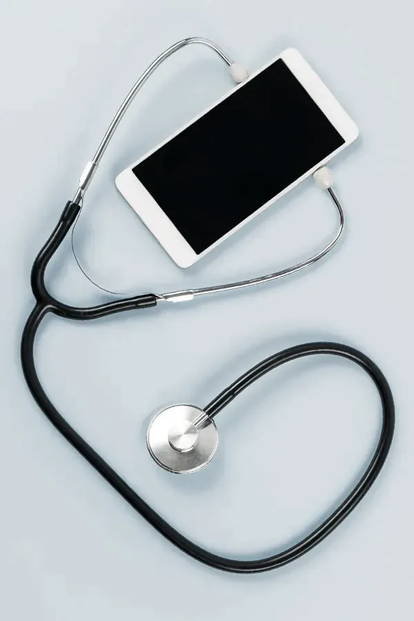 Telemedicine-Treatment A smartphone with a stethoscope attached to it, symbolizing Telemedicine treatment from Julie Kane, NP in Newfoundland.